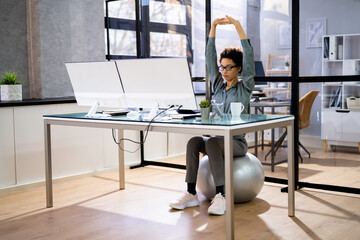 Businesswoman Sitting On Fitness Ball Working