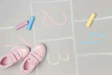 Pink sneakers and hopscotch game. Top view Flat lay