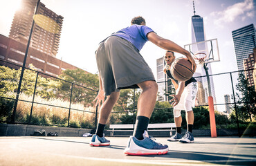 Two basketball players playing hard on the court. Street basketball challenge in New york. Concept...