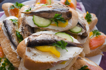 Sandwich, sandwich with salmon and sprats on a plate. Macro background. High quality photo. Banquet.