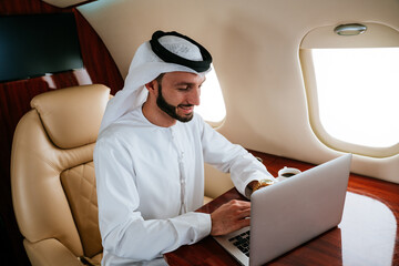 Business man from united arab emirates flying on his private jet to Dubai.  Successful speaker...