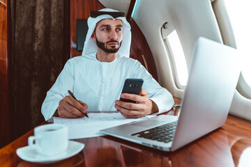 Business man from united arab emirates flying on his private jet to Dubai.  Successful speaker...