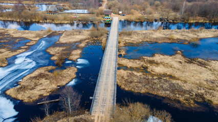 The top view on flood of the river, bridge and forest. High water at early spring.