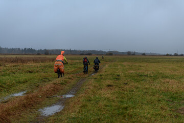 Russian bicyclists in the autumn field, Moscow Region