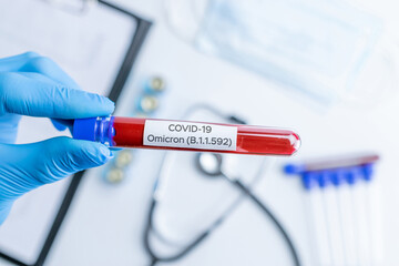 Omicron mutation coronavirus variant. Medical laboratory doctor holding test tube in hospital...