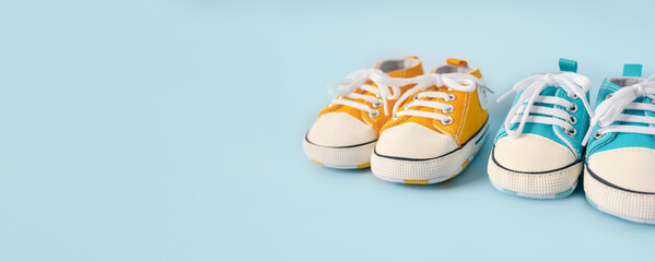 Baby's little shoes on a colorful background. The concept of waiting for a baby and the concept of...