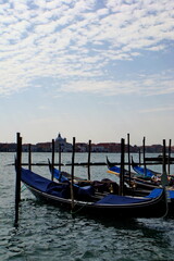 Fototapeta na wymiar Venetian empty gondolas in a lagoon