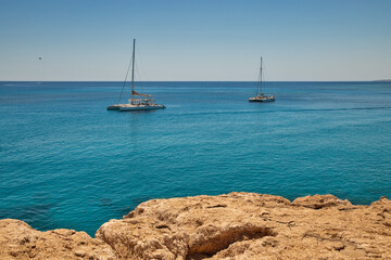 Catamarans in turquoise lagoon of the coast of Cyprus.