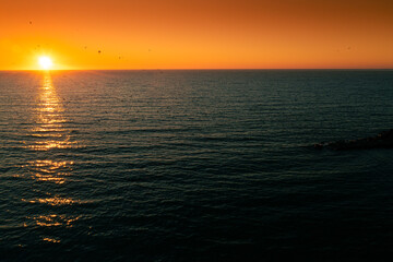Amazing sunrise at Black Sea shore in Romania, Constanta, with vivid sky color. Wonderful landscape at the seaside.