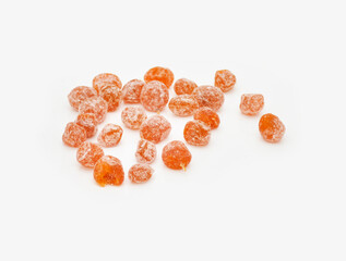 orange dried kumquat scattered on a white background
