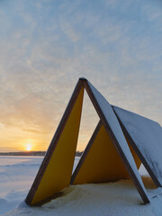 Winter sunset at the Finnish Tuusula lake: modern art and nature of northern Europe, cirrus clouds.