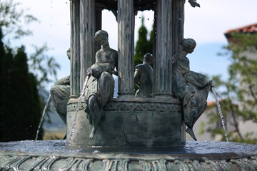 Obraz premium stone fountain in the shape of a woman pouring water from a jar.