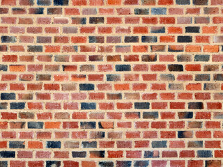 Red, brown and black brick wall background. Small bricks in perfect rows