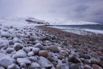 Gloomy February day on the shore of the Barents Sea. Neighborhood of Teriberka village. Murmansk region, Russia