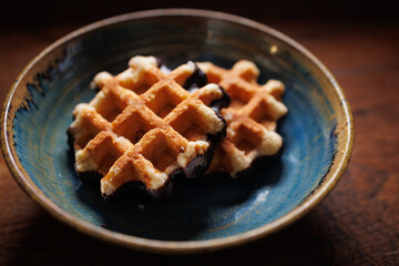 Two waffles in handmade clay plate