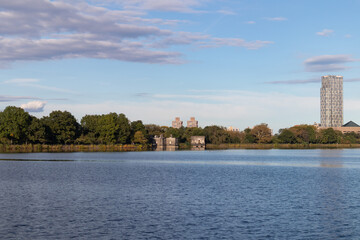 Central Park Reservoir with Green Trees and a Blue Sky in New York City