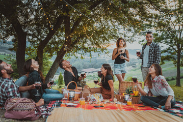 Group of friends eating in the nature