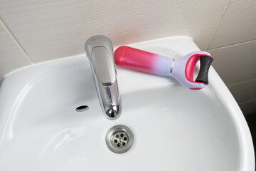 electric callus remover machine closeup remove old skin care treatment bathroom sink