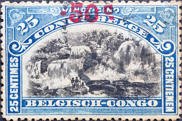 Belgian Congo - circa 1915: a postage stamp from Belgian Congo, showing a landscape with people in...