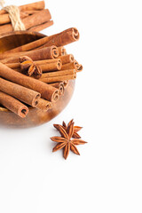 Anise stars and cinnamon sticks isolated on white background. Aromatic spices close-up