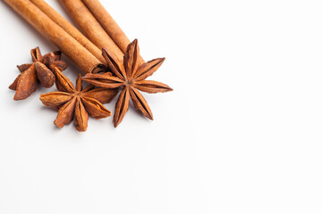 Anise stars and cinnamon sticks isolated on white background. Aromatic spices close-up