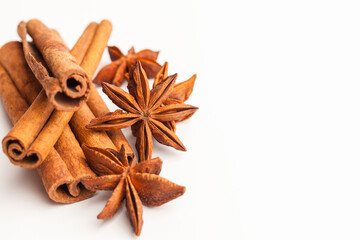 Anise stars and cinnamon sticks isolated on white background. Aromatic spices close-up