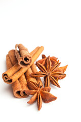 Anise stars and cinnamon sticks isolated on white background. Aromatic spices close-up