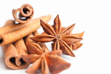 Anise stars and cinnamon sticks isolated on white background. Aromatic spices close-up
