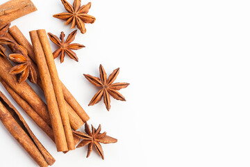 Anise stars and cinnamon sticks isolated on white background. Aromatic spices close-up