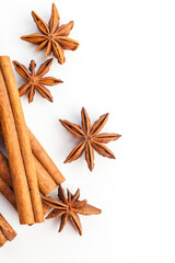 Anise stars and cinnamon sticks isolated on white background. Aromatic spices close-up