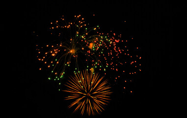 Colorful salute, great explodes in different colors in the night sky, beautifully dissolving in the air.
