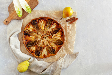 Homemade endive, pear and gorgonzola tart, flatlay, copy space