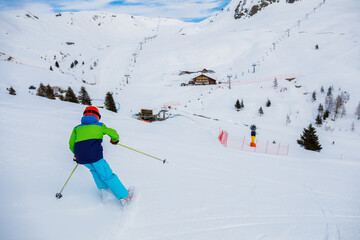 Boy skier enjoys the winter ski resort.