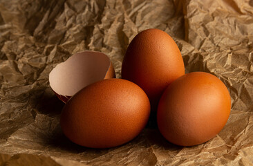 Chicken fresh eggs close-up on kraft paper