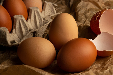 Chicken eggs in an egg box, close-up on kraft paper