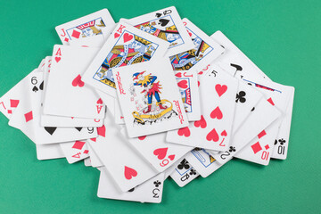 Playing cards on green background.