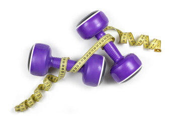 Dumbbells and measuring tape on white background