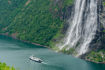 Ferry passing the famous Seven Sisters waterfall in the Geiranger Fjord, Norway.