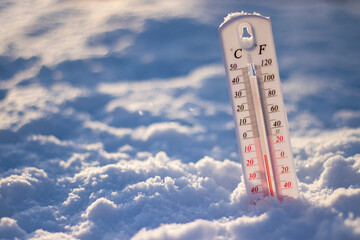 Thermometer in the snow. Extreme cold temperature at winter