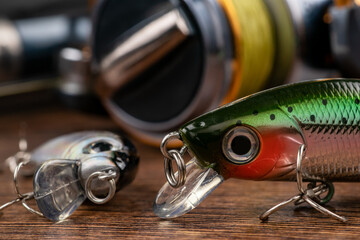 Colorful fishing lures, wobbler, spinner, on wood desk different fishing baits.