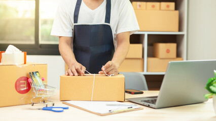 new generation entrepreneur Use smartphones and notebook computers to take customer orders and take notes. Order and prepare shipping packages online to order and prepare packaged products.