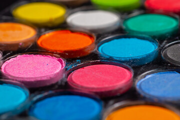 A set of colored paints in a box