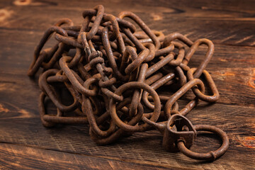 Vintage style, old rusty steel chain, on wooden background