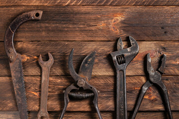 Dirty set of hand tools on a wooden boards