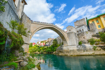 Fototapeta na wymiar Wide angle, water level shot of the Mostar Bridge or Stari Most, the rebuilt 16th century Ottoman bridge in Mostar, Bosnia and Herzegovina.