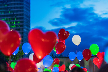 Fototapeta na wymiar LED balloons in evening sky, Valentine's Day. Romantic background. Holiday concept