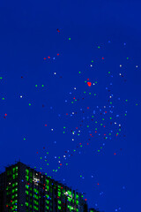 Fototapeta premium Colorful balloons fly in night sky. Concept of holiday, happy birthday, wedding