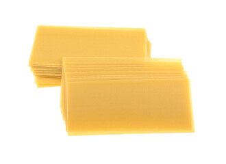 Uncooked raw lasagna pasta isolated on white background. Stack of dried uncooked lasagna pasta sheets