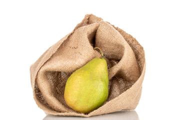 One sweet juicy pear with burlap sack, macro, isolated on white background.