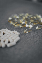 Vitamins and dietary supplements close-up. Macrophoto of capsules. Vitamins on the table.